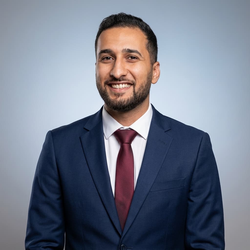 Portrait of Hossam El-Elimy in a navy suit and burgundy tie.